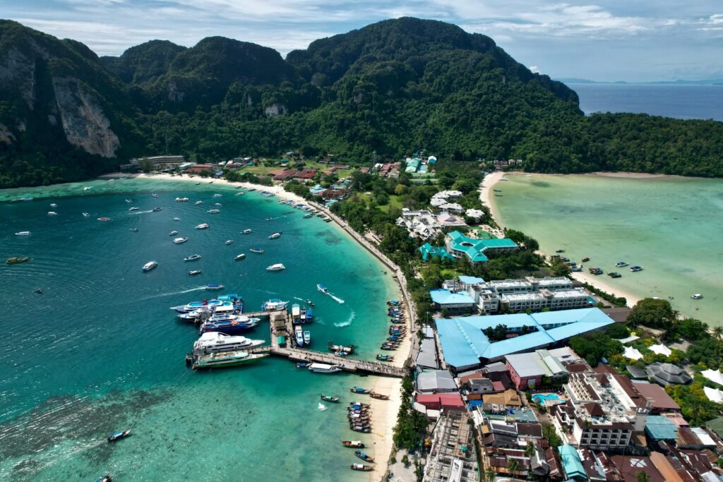 Stunning aerial shot of Tonsai Village, Phi Phi Islands with vibrant turquoise waters and lush hills.