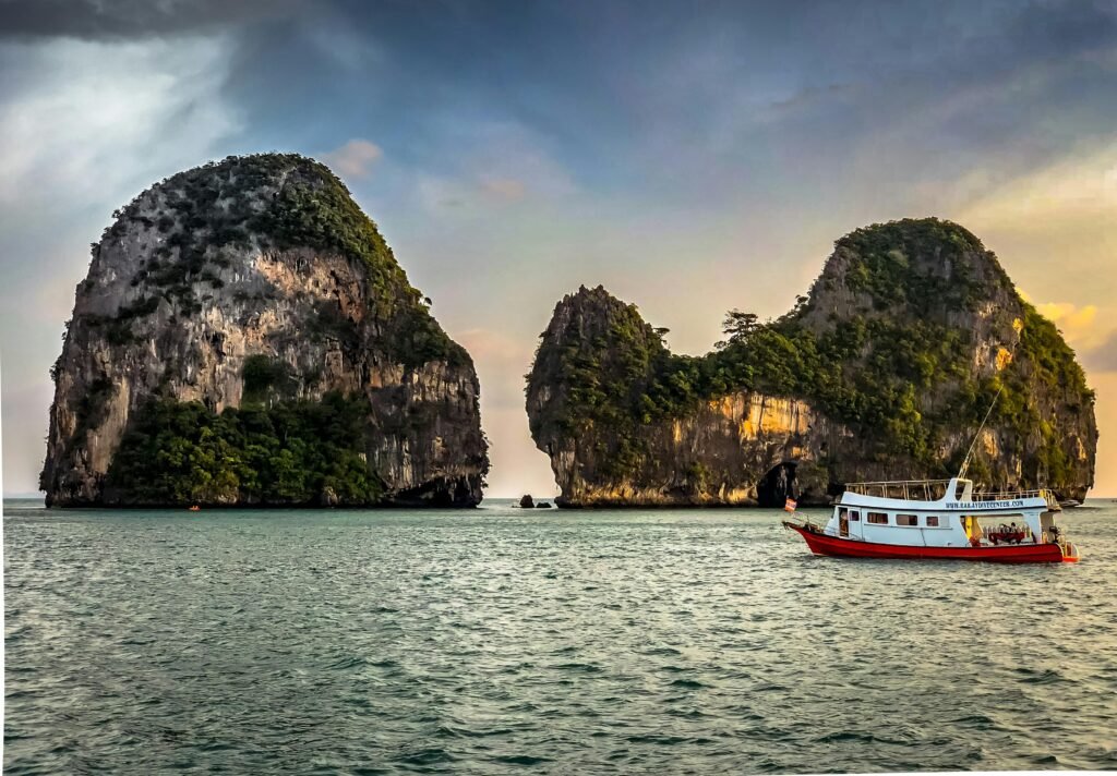 Explore the stunning limestone islands off the coast of Krabi, Thailand, with a vibrant boat.