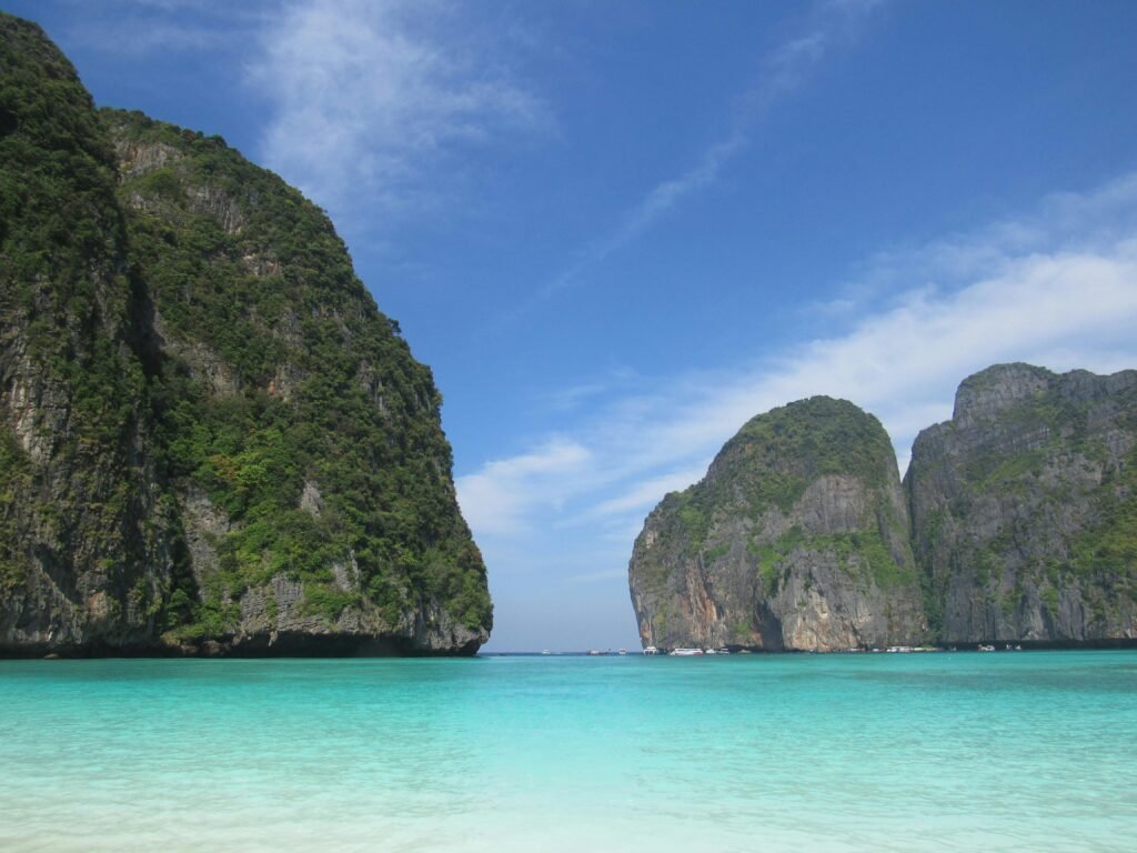 Stunning blue waters and towering limestone cliffs in a serene tropical bay.