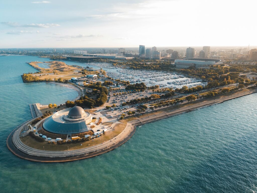 Stunning aerial view of a lakeside cityscape with a prominent dome structure.