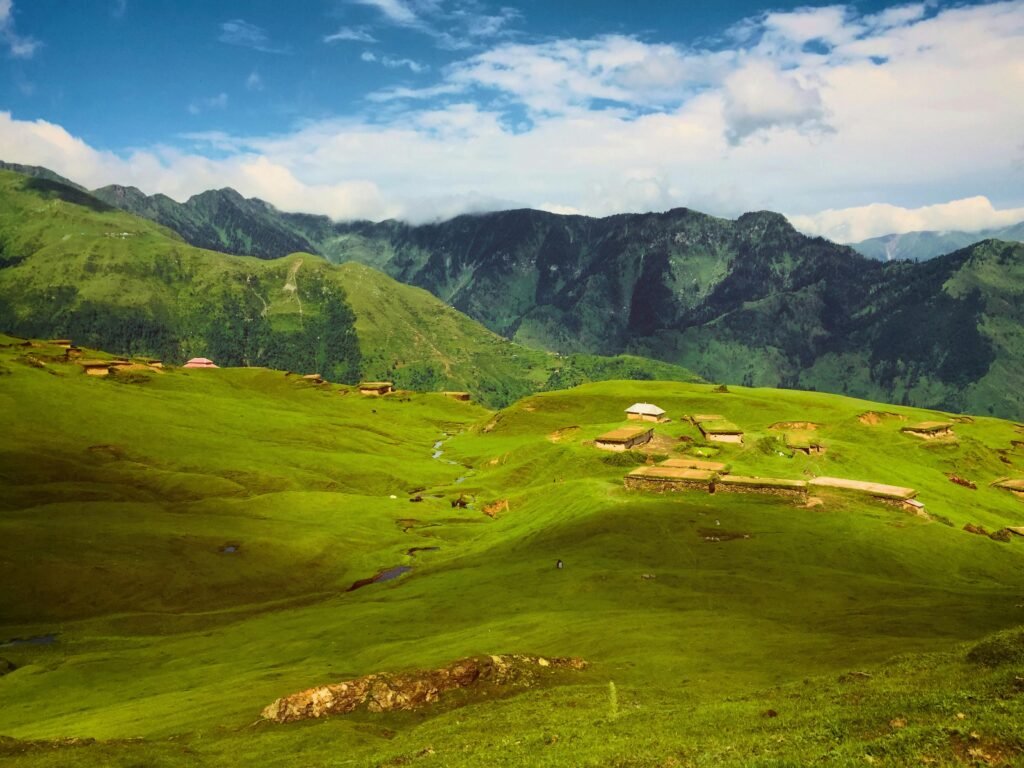 Breathtaking view of lush green hills and mountains in Haveli Azad Kashmir, perfect for a nature escape.