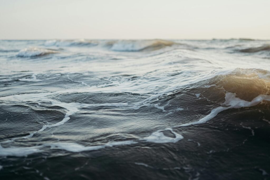 Serene ocean waves in motion at sunset, embodying tranquility and nature's beauty.