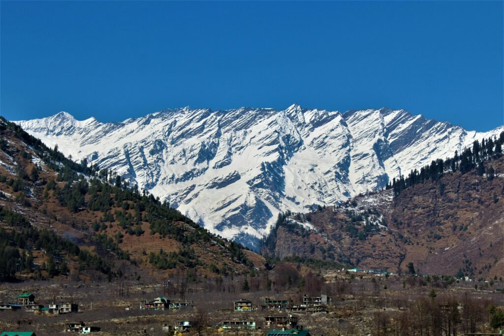 Stunning snow-covered mountains with settlements nestled in the valley below.