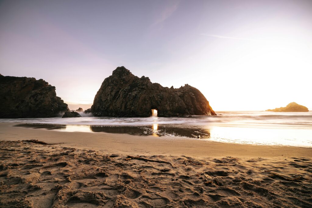 Breathtaking sunset at Pfeiffer Beach highlighting unique rock formations and serene ocean views.