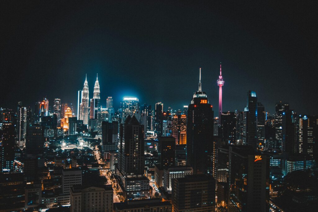 Stunning night view of Kuala Lumpur skyline featuring iconic towers and vibrant city lights.