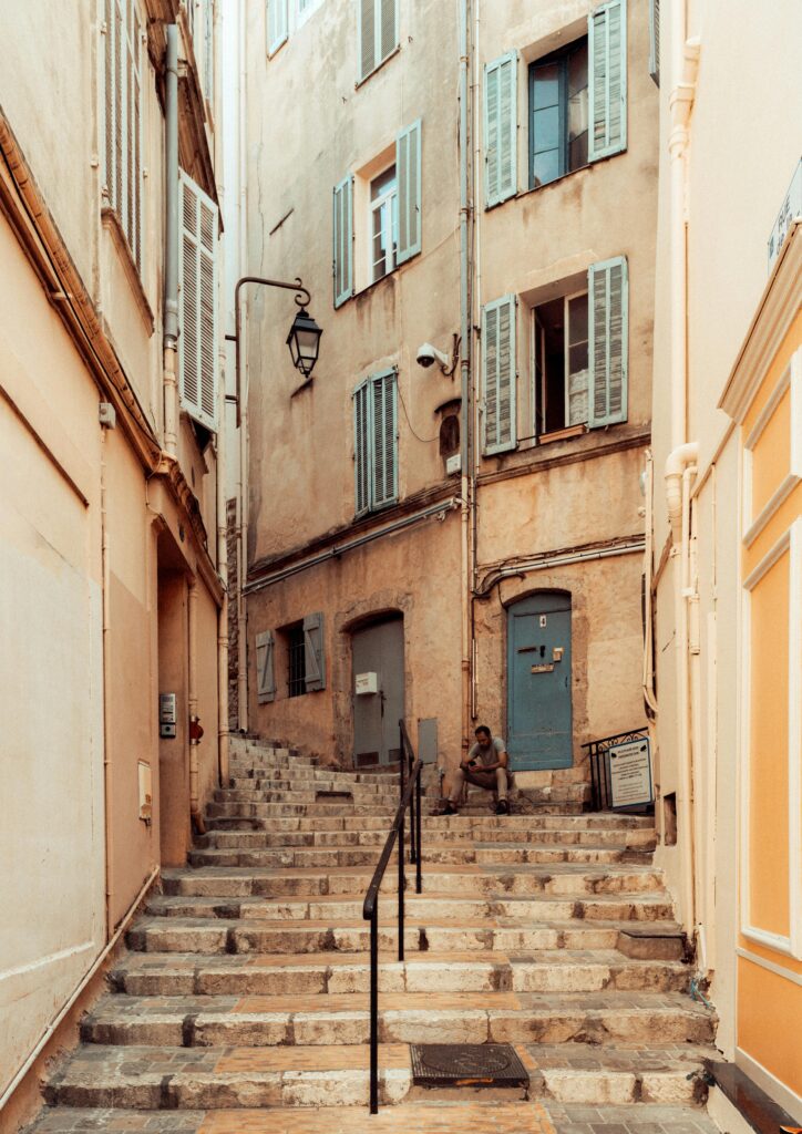 Quaint alley in Cannes with stone steps and classic French architecture.